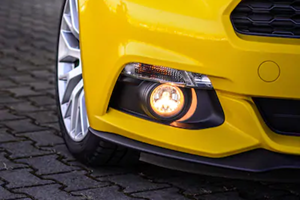 Car bumper with a fog lamp integrated into the design, featuring a sleek, round shape for improved visibility in low-light conditions.