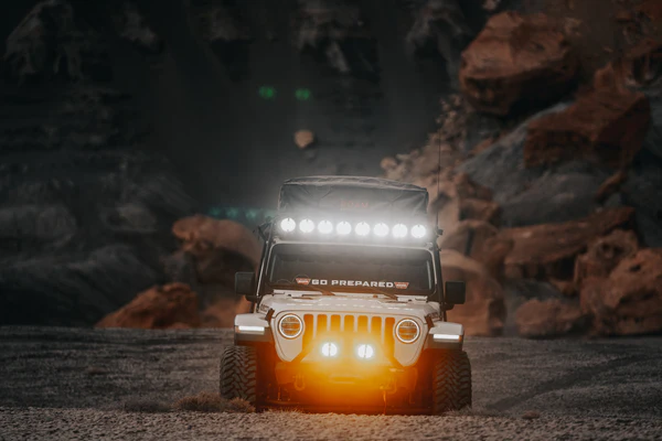 Off-road vehicle fog light with a rugged design, featuring a durable housing and bright, focused LED beam, mounted on the front bumper for enhanced visibility in challenging terrains